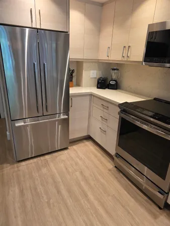 a kitchen with a refrigerator stove and microwave