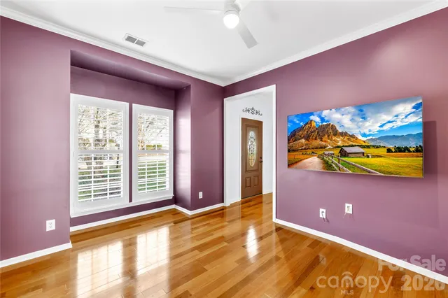 a view of empty room with window and fireplace