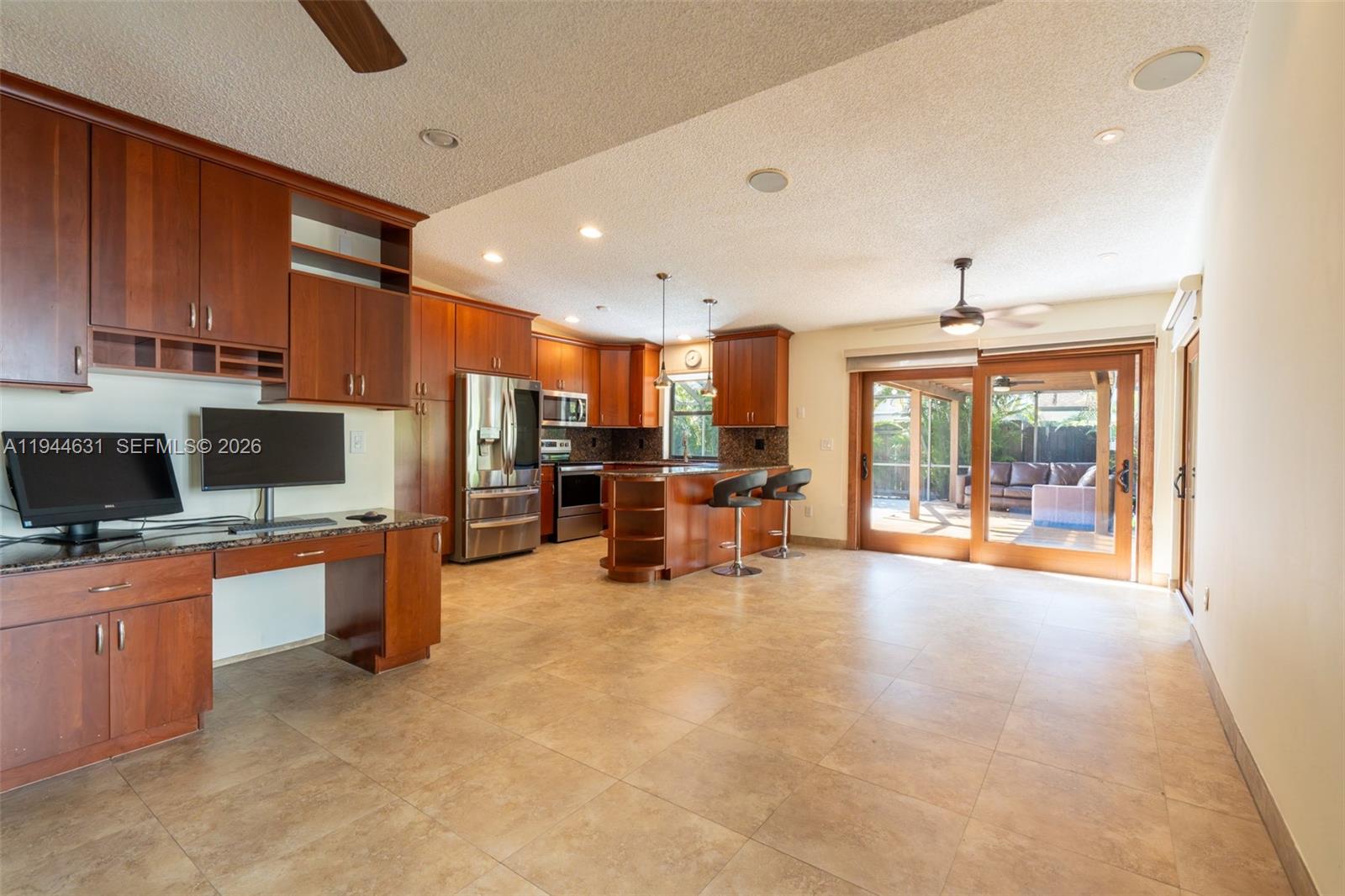 10116 Southwest 144th Place Miami, FL 33186 - Photo 14 of 28 a room with furniture and a flat screen tv