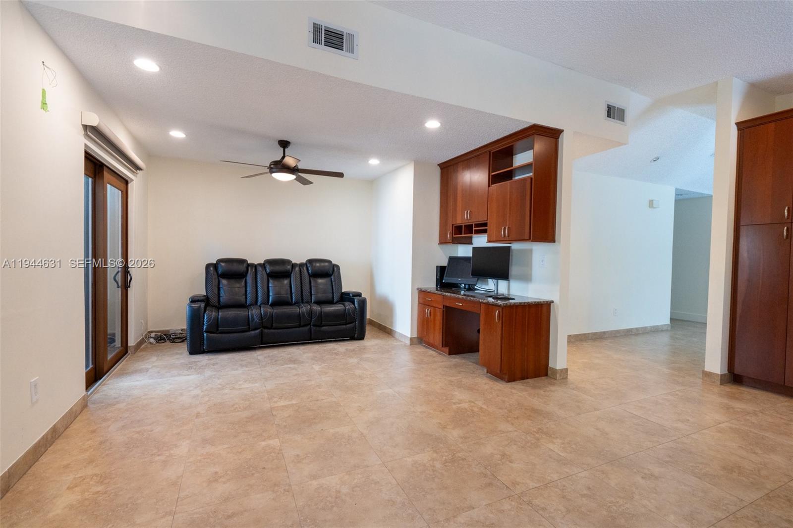 10116 Southwest 144th Place Miami, FL 33186 - Photo 15 of 28 a living room with furniture and a flat screen tv