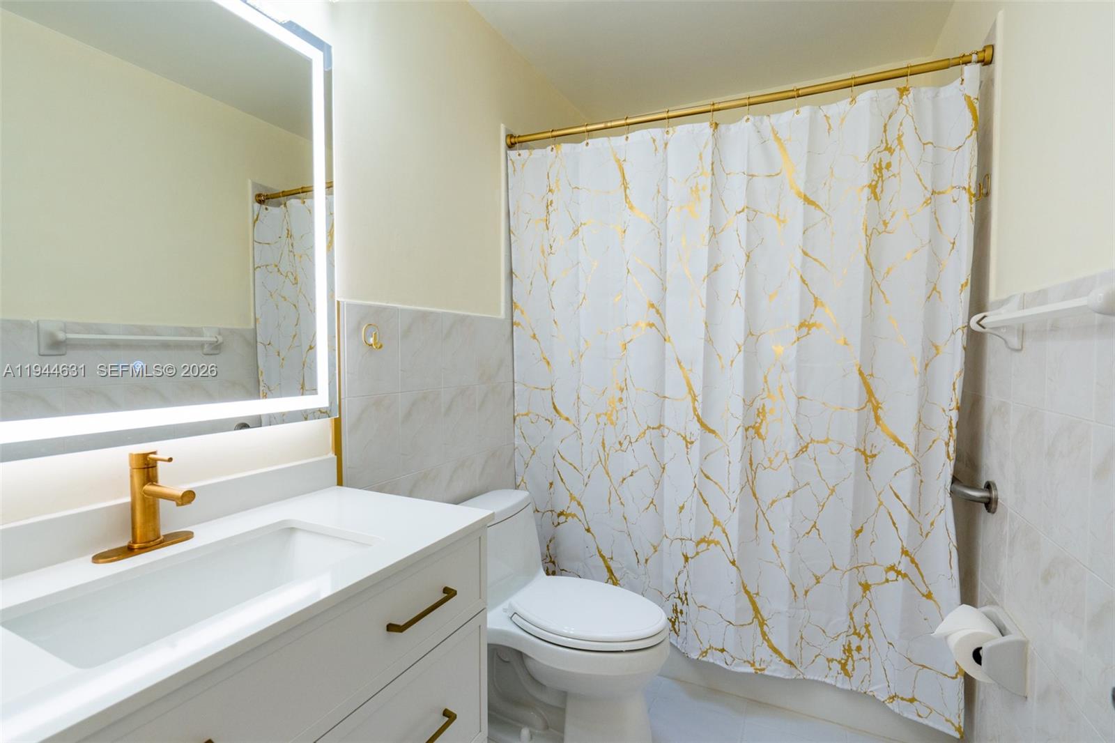 10116 Southwest 144th Place Miami, FL 33186 - Photo 16 of 28 a bathroom with a sink a toilet and a mirror