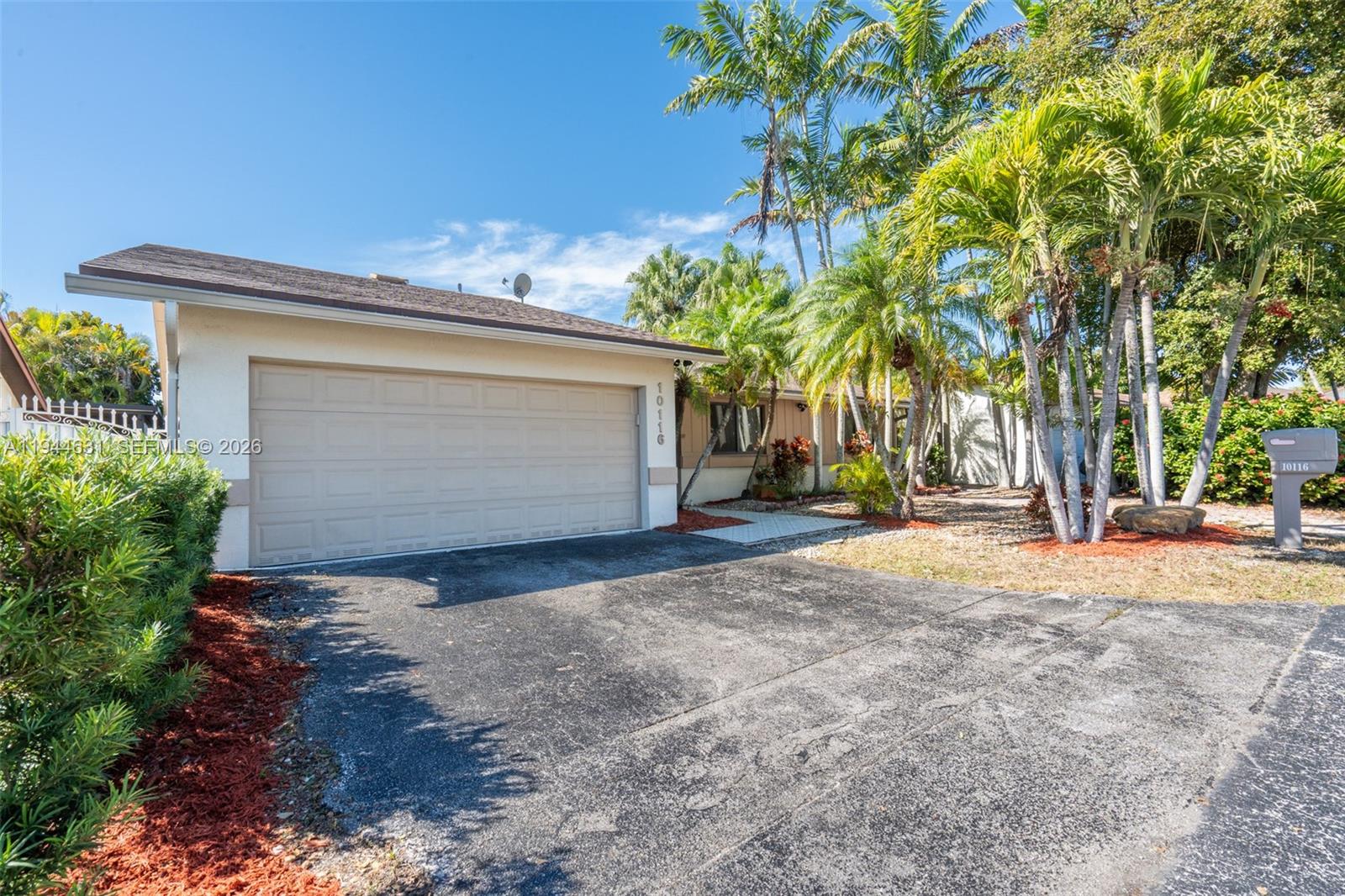 10116 Southwest 144th Place Miami, FL 33186 - Photo 21 of 28 a view of a house with a yard and garage
