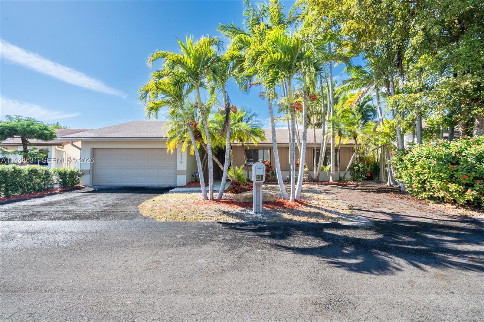 10116 Southwest 144th Place Miami, FL 33186 - Photo 22 of 28 a view of a house with small yard plants and palm trees