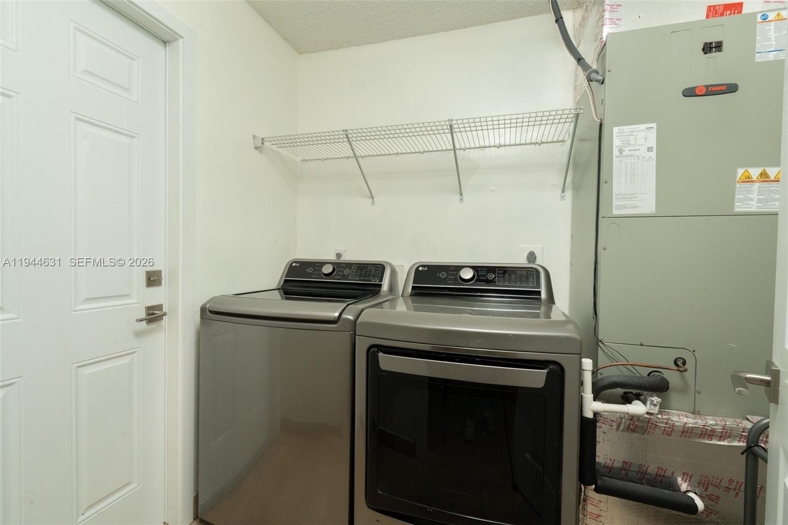 10116 Southwest 144th Place Miami, FL 33186 - Photo 28 of 28 a view of a storage & utility room with racks on the wall
