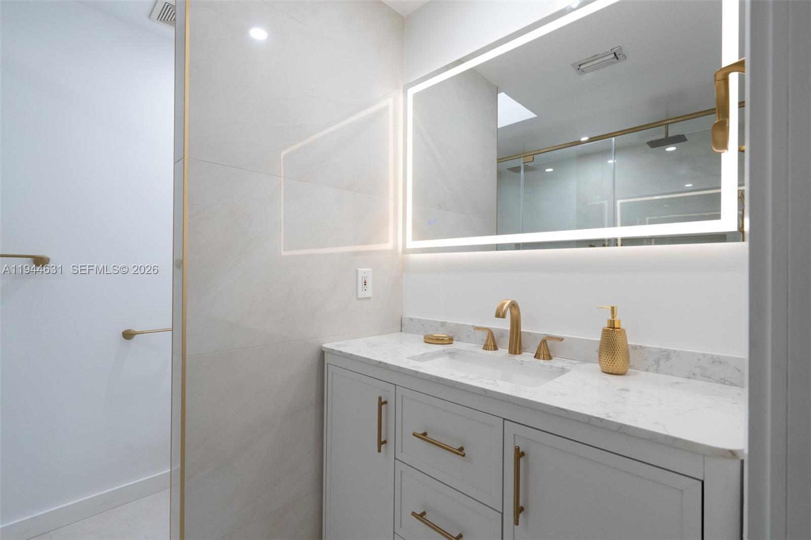 10116 Southwest 144th Place Miami, FL 33186 - Photo 4 of 28 a bathroom with a sink and a mirror