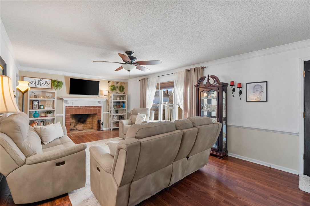 112 C-10-220 Anderson, SC 29621 - Photo 11 of 45 This inviting living room boasts a charming brick fireplace and rich hardwood flooring.