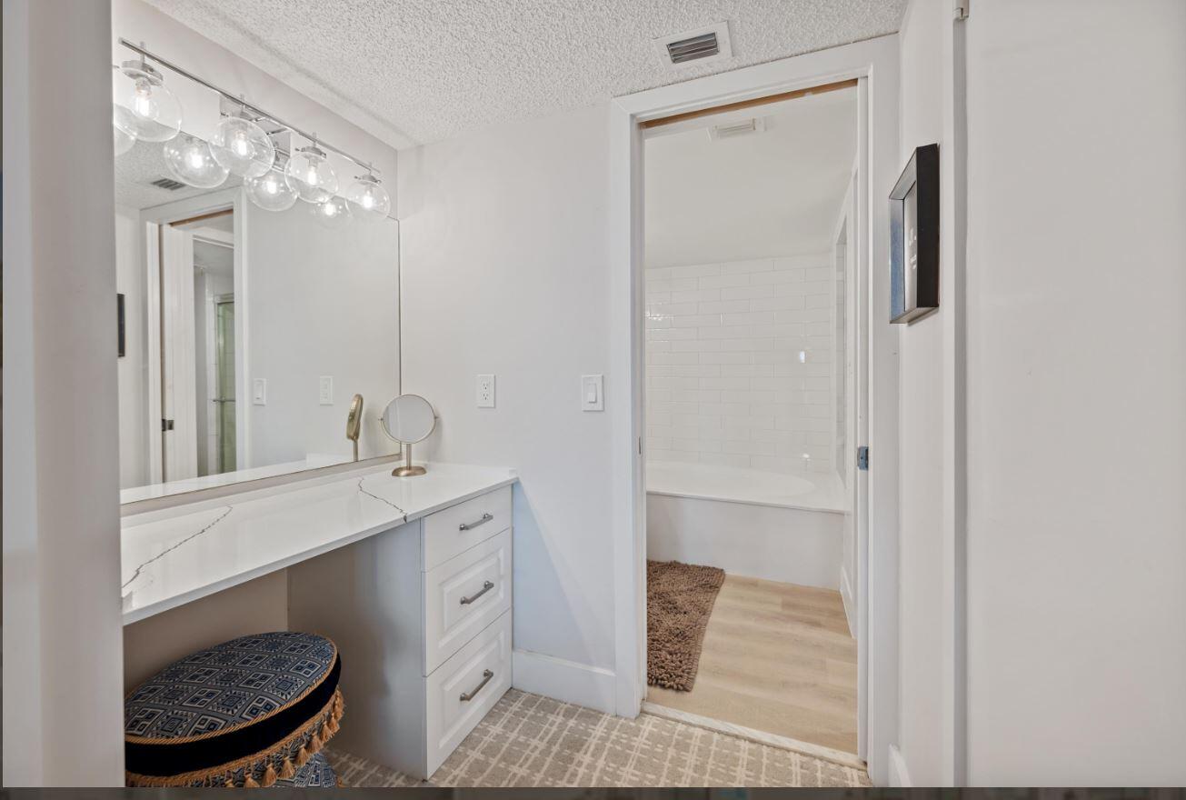 500 Ocean Trail Way, Unit 506 Jupiter, FL 33477 - Photo 18 of 28 a bathroom with a sink a toilet a mirror and shower