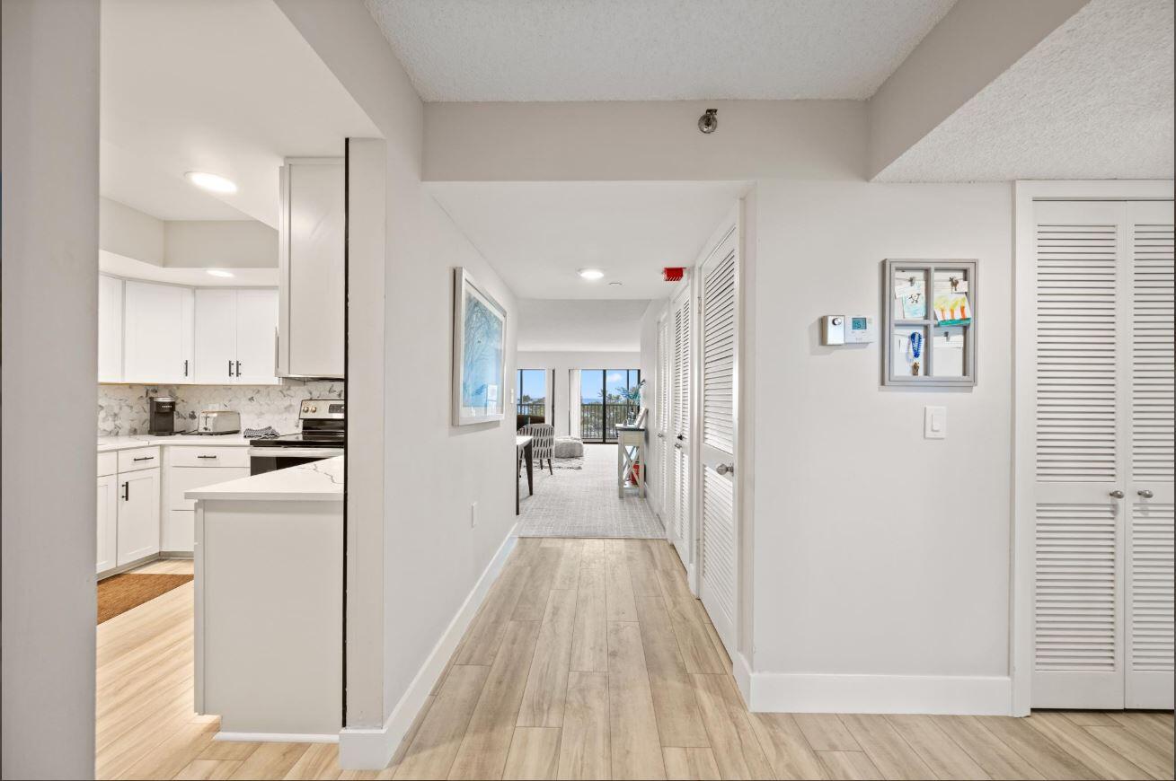 500 Ocean Trail Way, Unit 506 Jupiter, FL 33477 - Photo 9 of 28 a view of a kitchen with refrigerator and wooden floor