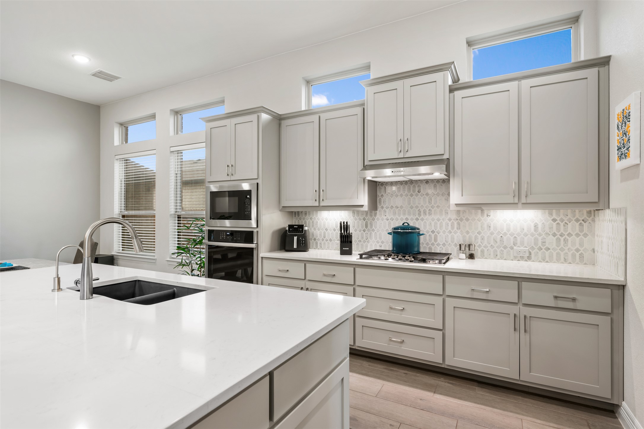 2501 Costera Street Leander, TX 78641 - Photo 10 of 40 Under cabinet lighting highlights the beautiful backsplash.