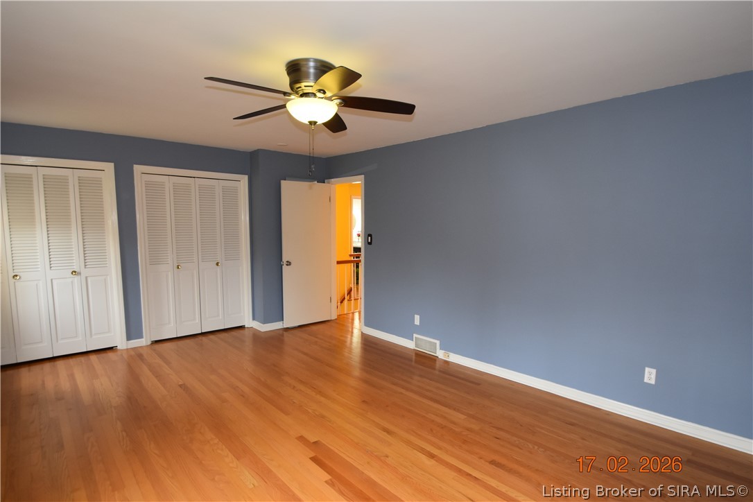 1905 Blackiston Mill Road Clarksville, IN 47129 - Photo 31 of 64 Primary bedroom. Wood floors, ceiling fan and two closets.