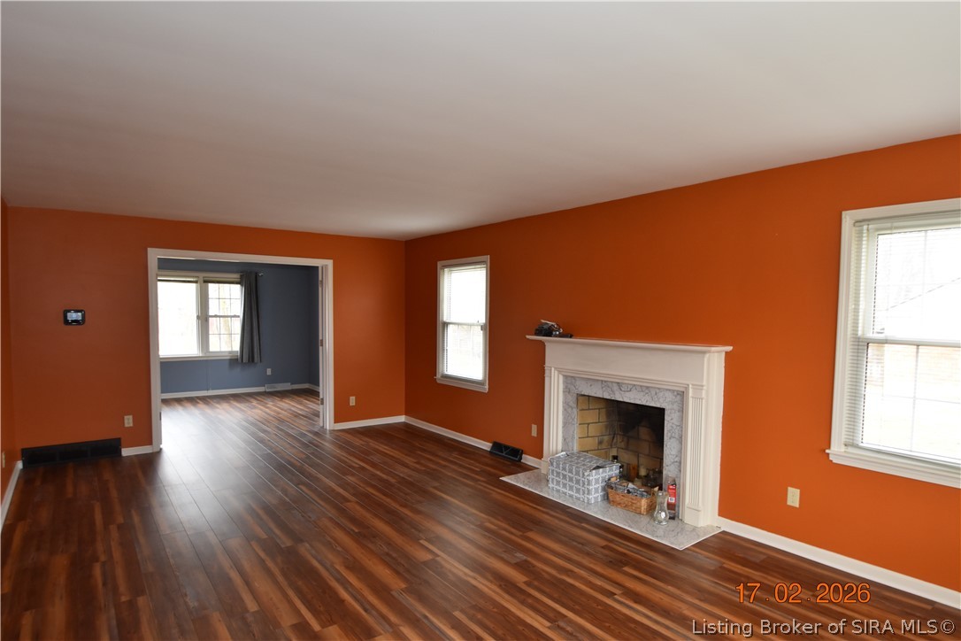 1905 Blackiston Mill Road Clarksville, IN 47129 - Photo 5 of 64 Woodburning fireplace in the living room. Bonus room is visible in the background.