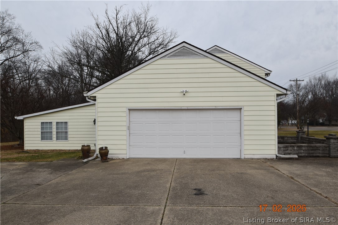 1905 Blackiston Mill Road Clarksville, IN 47129 - Photo 56 of 64 Two car garage, view of sunroom. Extra wide driveway.