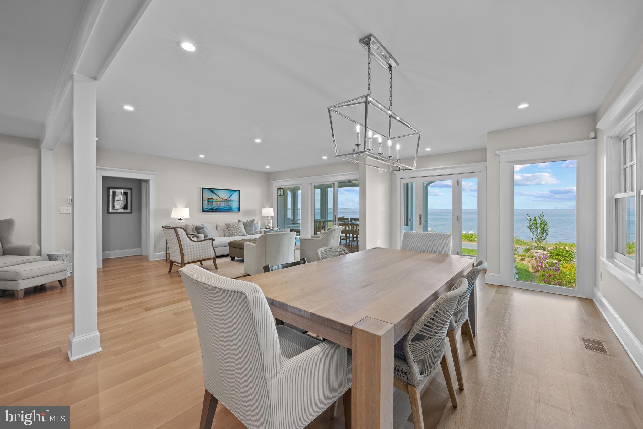 54 River Drive Annapolis, MD 21403 - Photo 11 of 43 a view of a dining room and livingroom with furniture wooden floor a chandelier