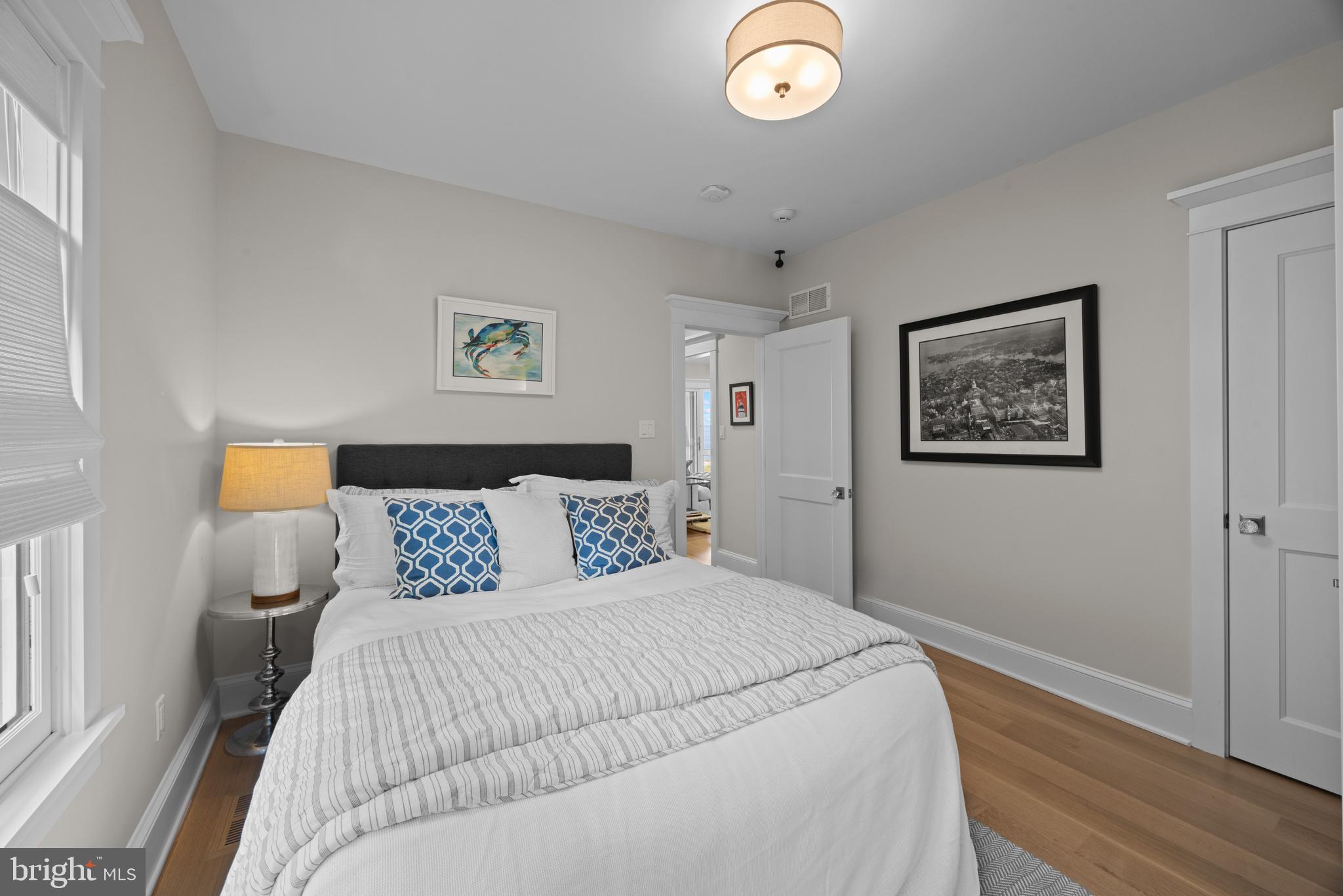 54 River Drive Annapolis, MD 21403 - Photo 16 of 43 a bedroom with a bed and a painting on the wall