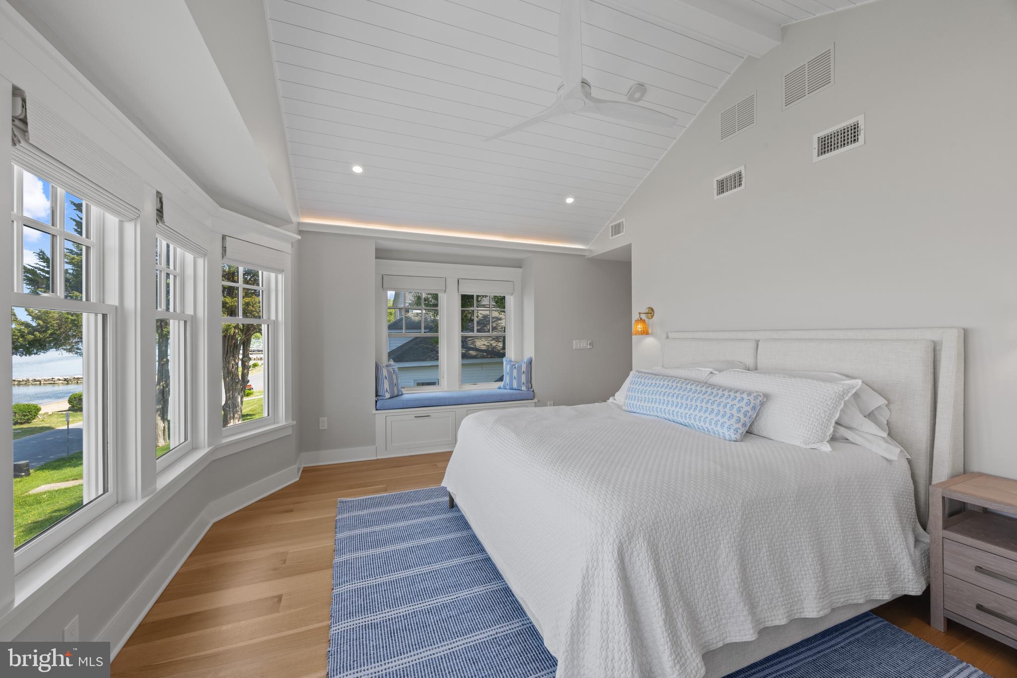 54 River Drive Annapolis, MD 21403 - Photo 23 of 43 a bedroom with a large bed and wooden floor