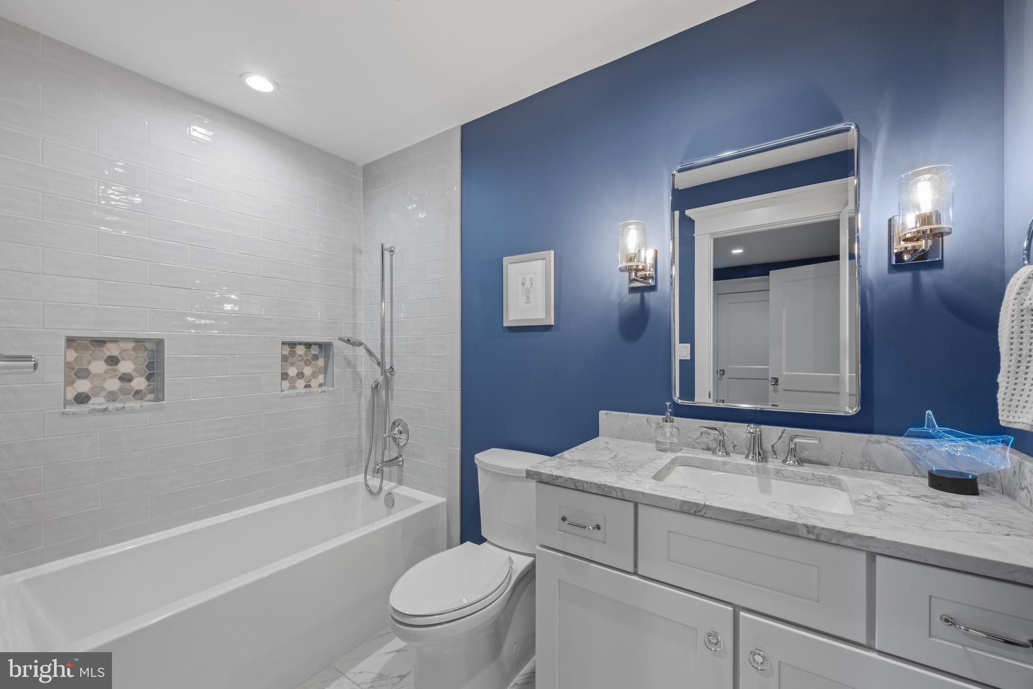 54 River Drive Annapolis, MD 21403 - Photo 29 of 43 a bathroom with a granite countertop toilet a sink and bathtub