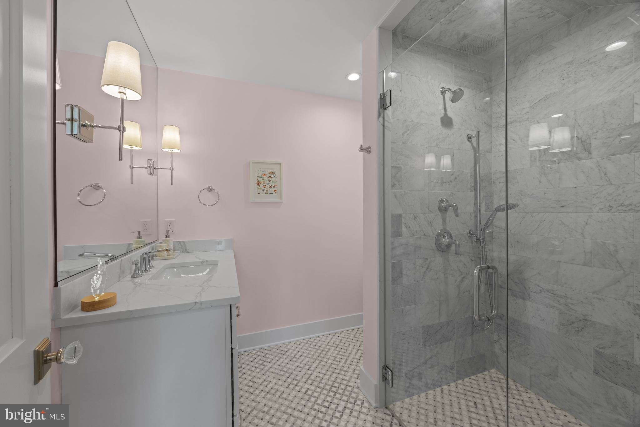 54 River Drive Annapolis, MD 21403 - Photo 31 of 43 a bathroom with a sink a shower and a mirror