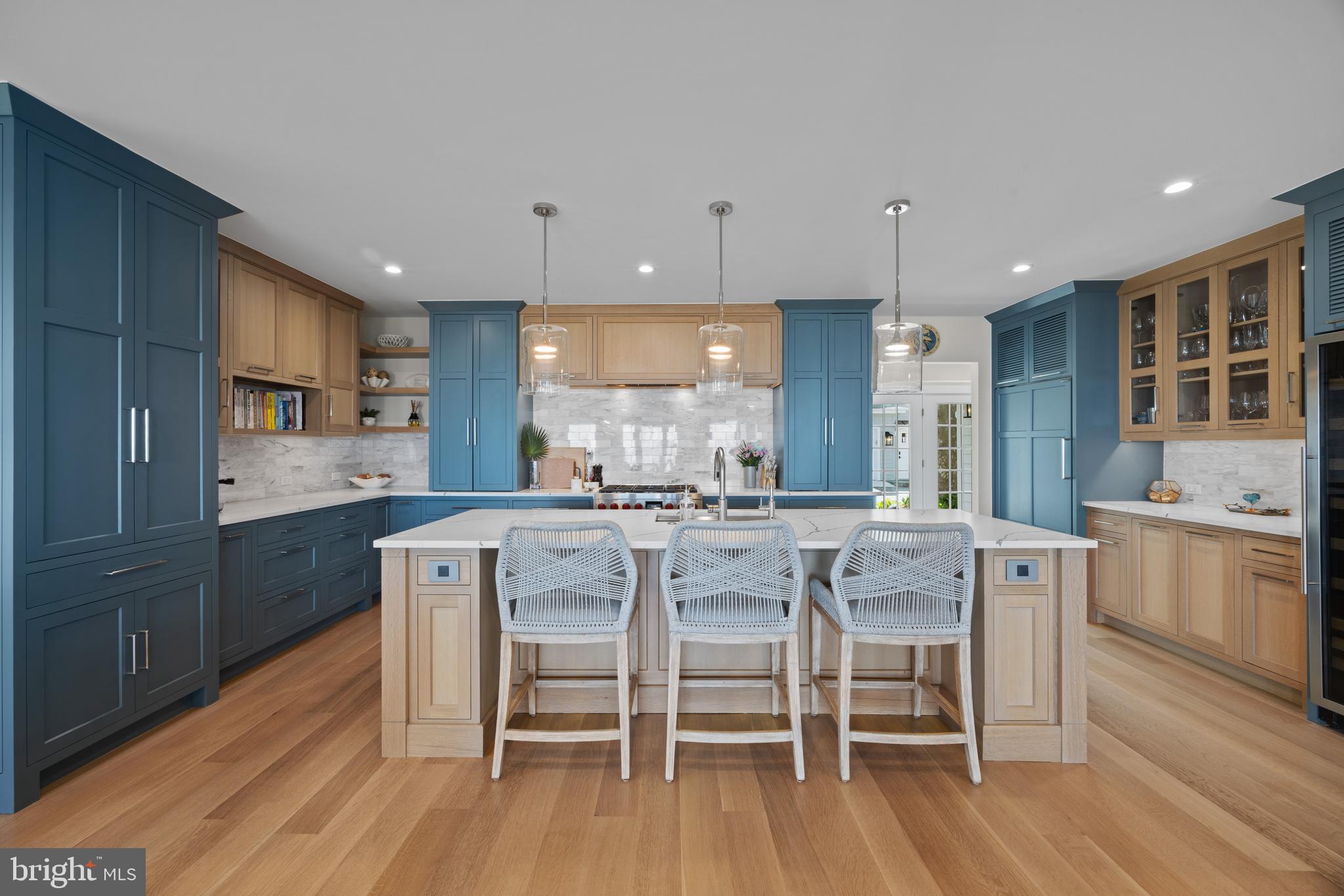 54 River Drive Annapolis, MD 21403 - Photo 7 of 43 a kitchen with stainless steel appliances a dining table chairs stove and cabinets