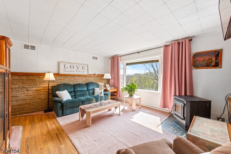 41 Swartswood Road Newton, NJ 07860 - Photo 11 of 22 a living room with furniture and a floor to ceiling window