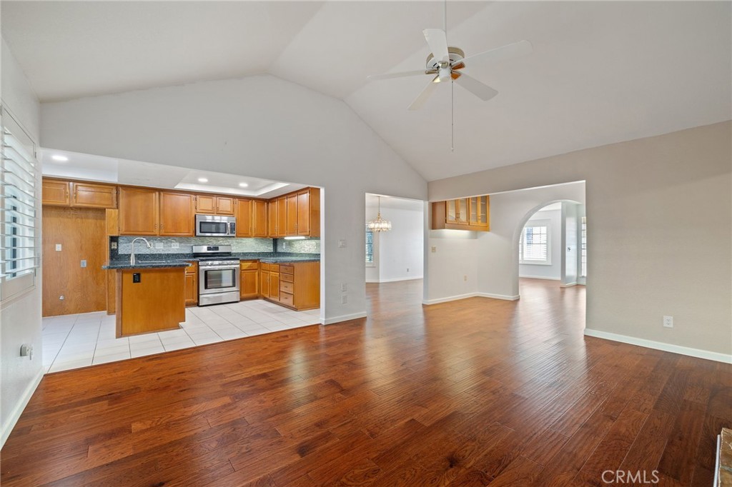 11030 Vicksburg Court Rancho Cucamonga, CA 91737 - Photo 14 of 53 a living room with stainless steel appliances granite countertop furniture wooden floor and a large window