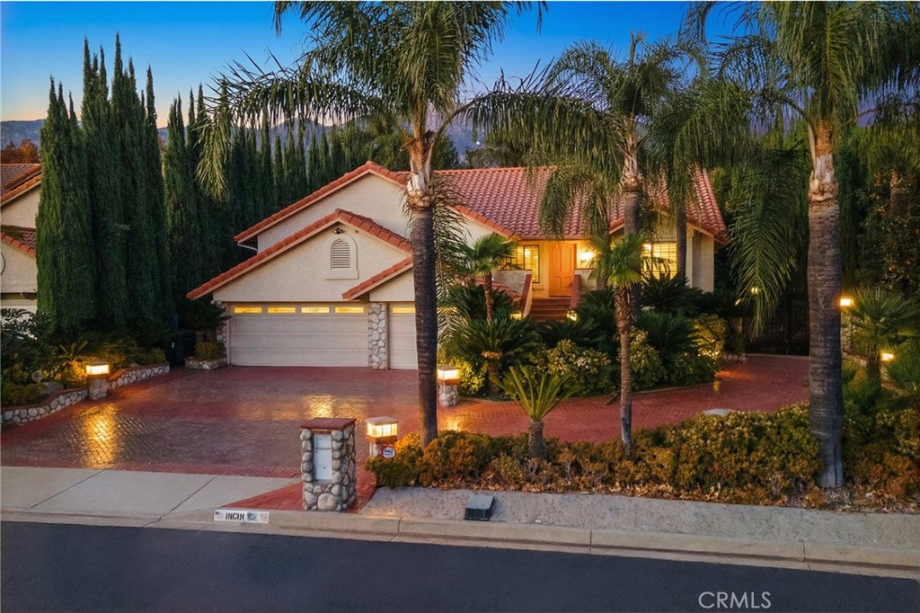 11030 Vicksburg Court Rancho Cucamonga, CA 91737 - Photo 2 of 53 front view of house with a yard and potted plants