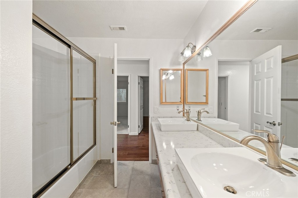 11030 Vicksburg Court Rancho Cucamonga, CA 91737 - Photo 28 of 53 a spacious bathroom with a double vanity sink mirror and shower