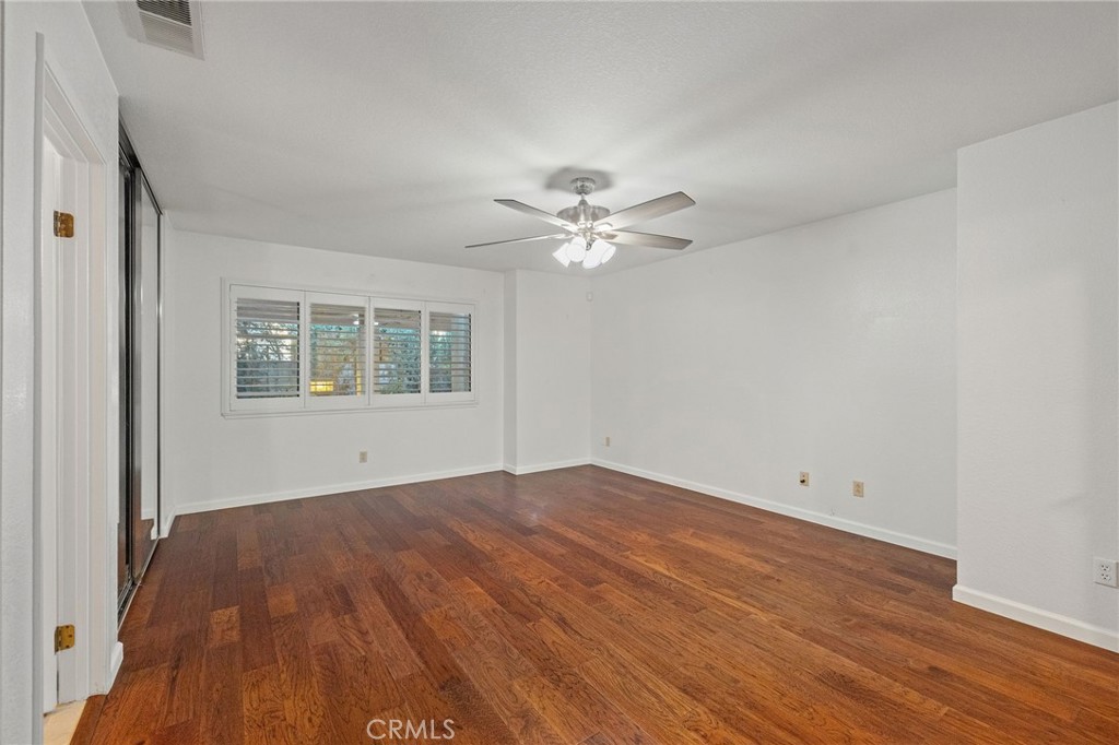 11030 Vicksburg Court Rancho Cucamonga, CA 91737 - Photo 34 of 53 a view of an empty room with wooden floor and a window