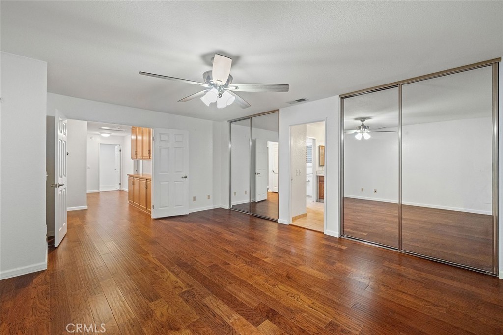 11030 Vicksburg Court Rancho Cucamonga, CA 91737 - Photo 35 of 53 a view of an empty room with wooden floor and a ceiling fan