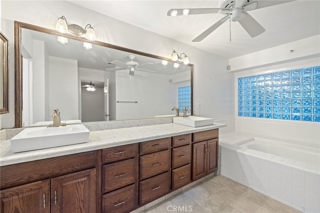 11030 Vicksburg Court Rancho Cucamonga, CA 91737 - Photo 36 of 53 a bathroom with a tub double vanity sink and a mirror