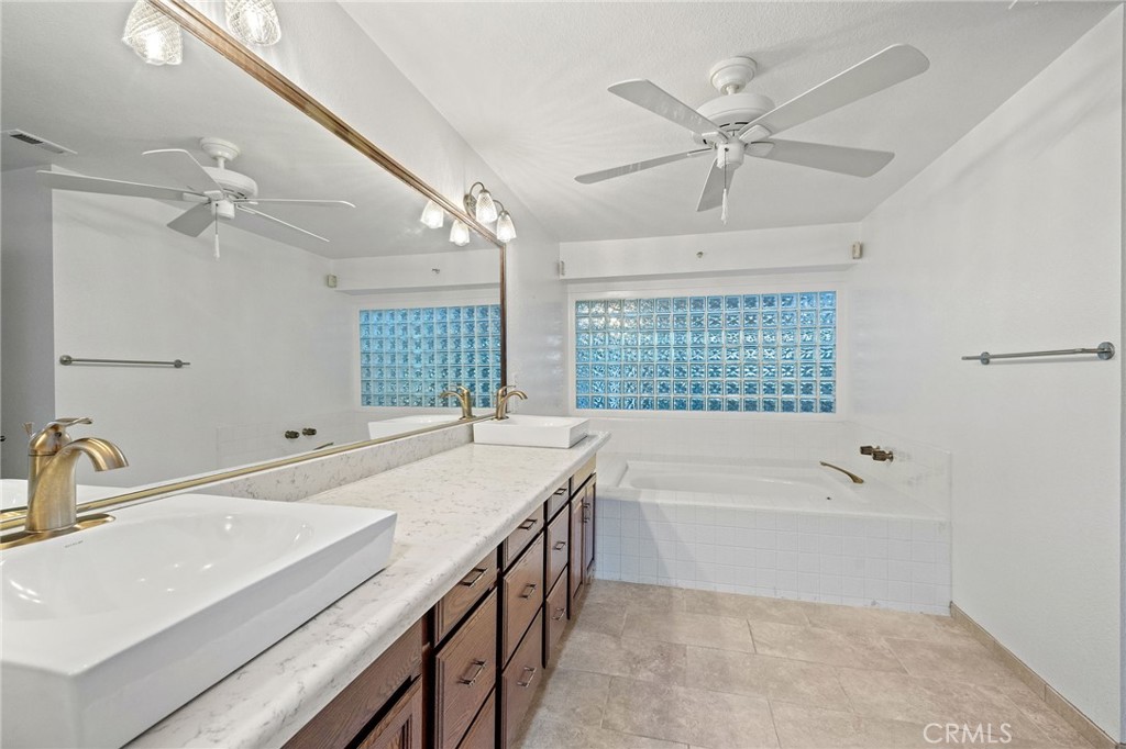 11030 Vicksburg Court Rancho Cucamonga, CA 91737 - Photo 37 of 53 a bathroom with a tub sink and mirror