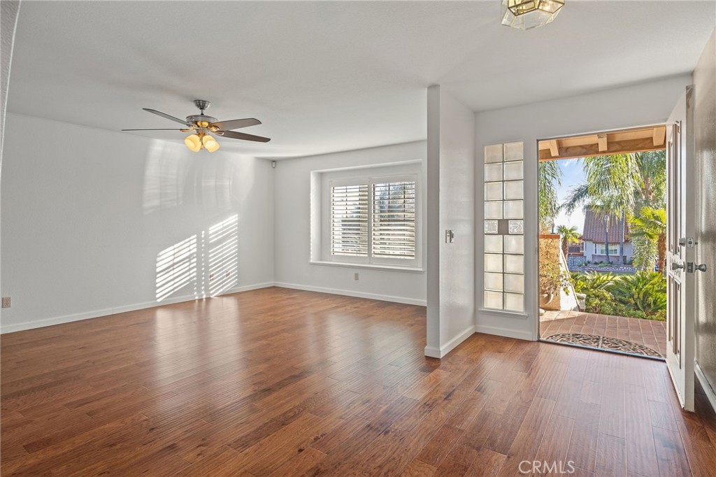 11030 Vicksburg Court Rancho Cucamonga, CA 91737 - Photo 7 of 53 a view of an empty room with a window and wooden floor