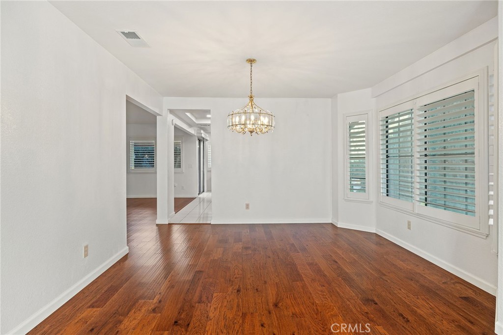 11030 Vicksburg Court Rancho Cucamonga, CA 91737 - Photo 10 of 53 a view of an empty room with wooden floor and a window