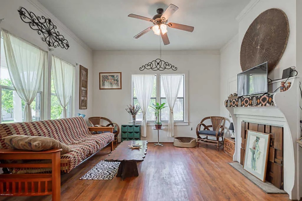 324 South 9th Street Fernandina Beach, FL 32034 - Photo 2 of 4 a living room with furniture a fireplace and a window