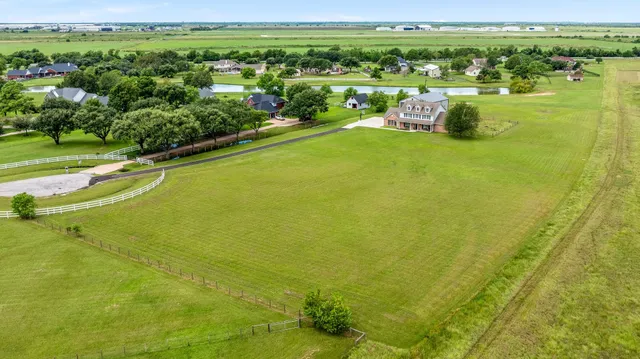 an aerial view of a house with swimming pool garden and outdoor seating