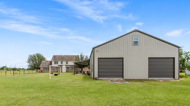 a view of an house with backyard space and garden