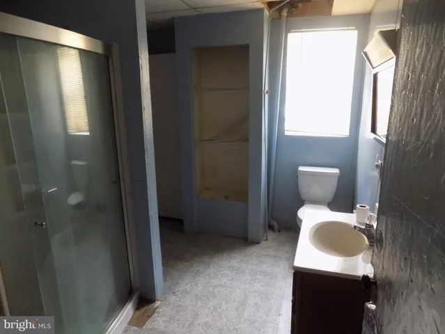 a bathroom with a toilet sink and mirror