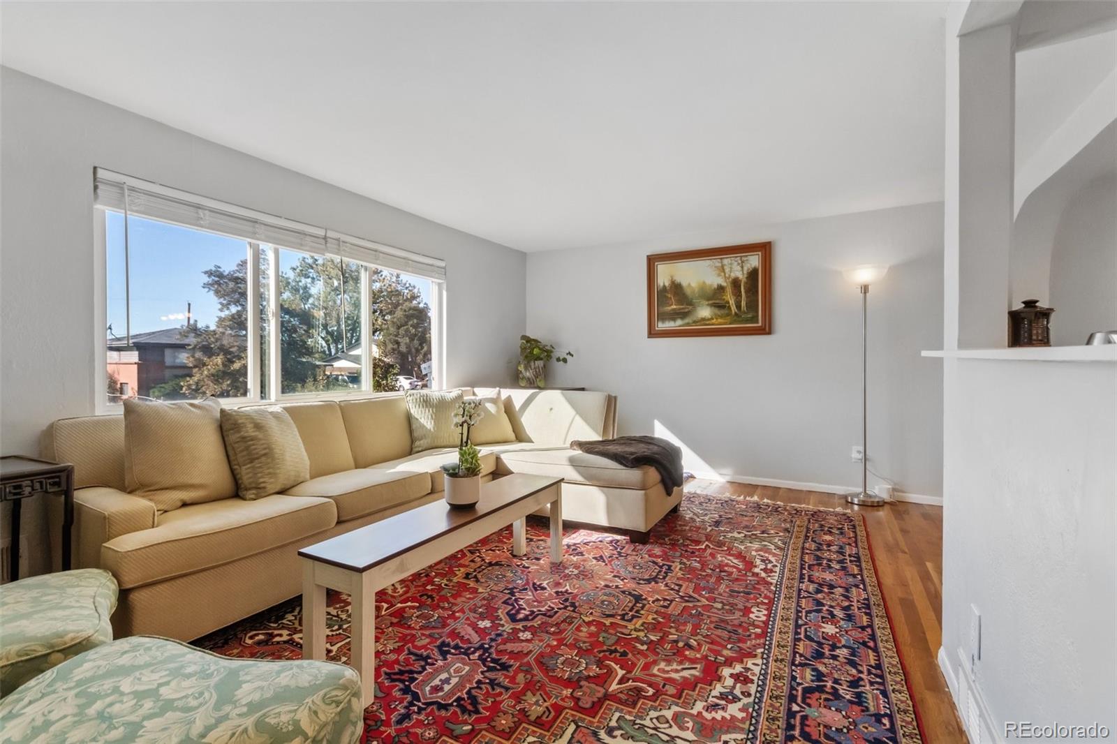 13436 Fitzsimons Way Aurora, CO 80011 - Photo 11 of 40 a living room with furniture and a rug