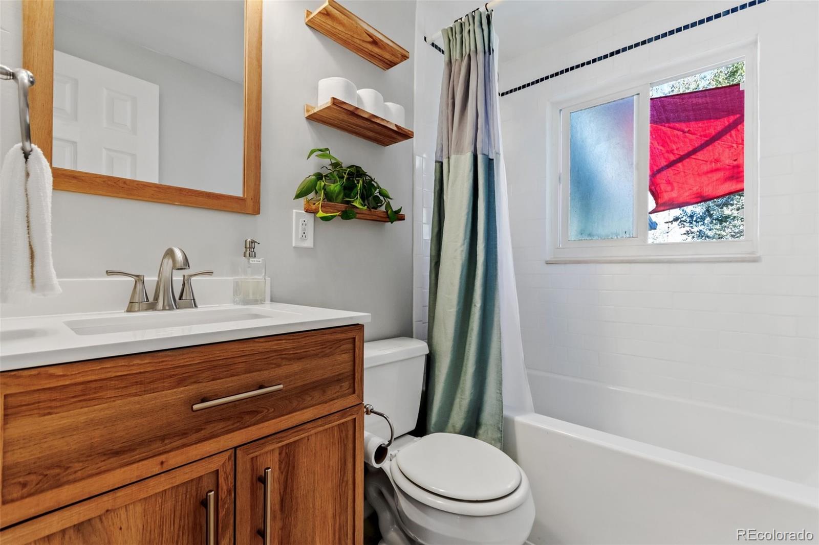 13436 Fitzsimons Way Aurora, CO 80011 - Photo 28 of 40 a bathroom with a sink a toilet and shower