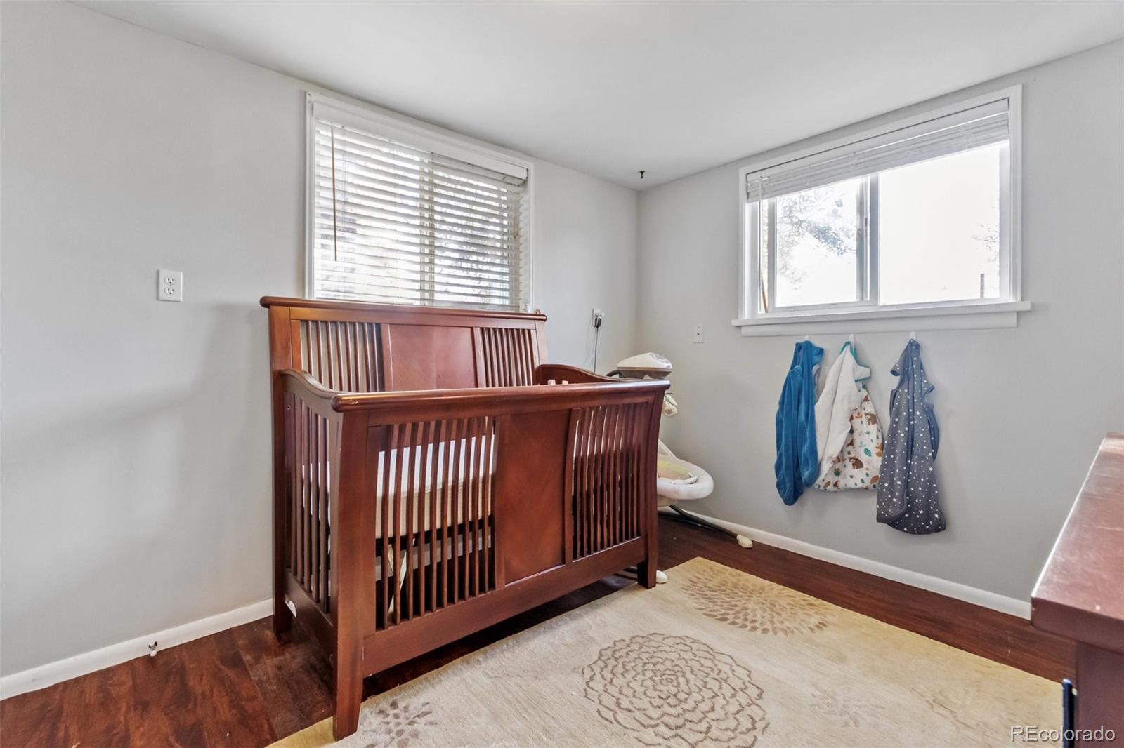 13436 Fitzsimons Way Aurora, CO 80011 - Photo 32 of 40 a view of a bedroom with furniture and windows