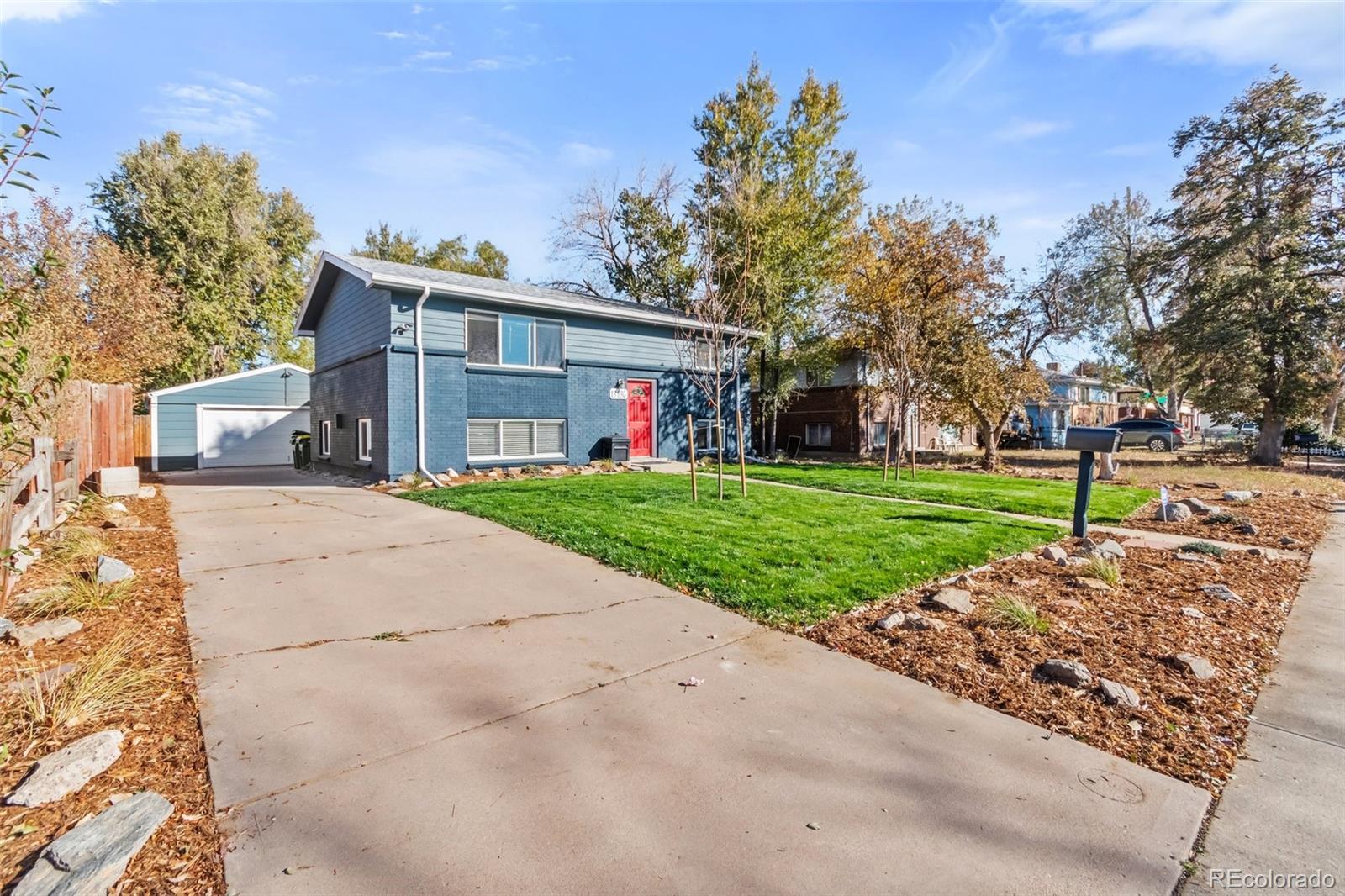13436 Fitzsimons Way Aurora, CO 80011 - Photo 7 of 40 front view of a house with a yard