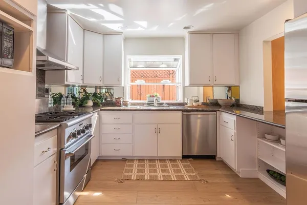 a kitchen with a sink stove and cabinets