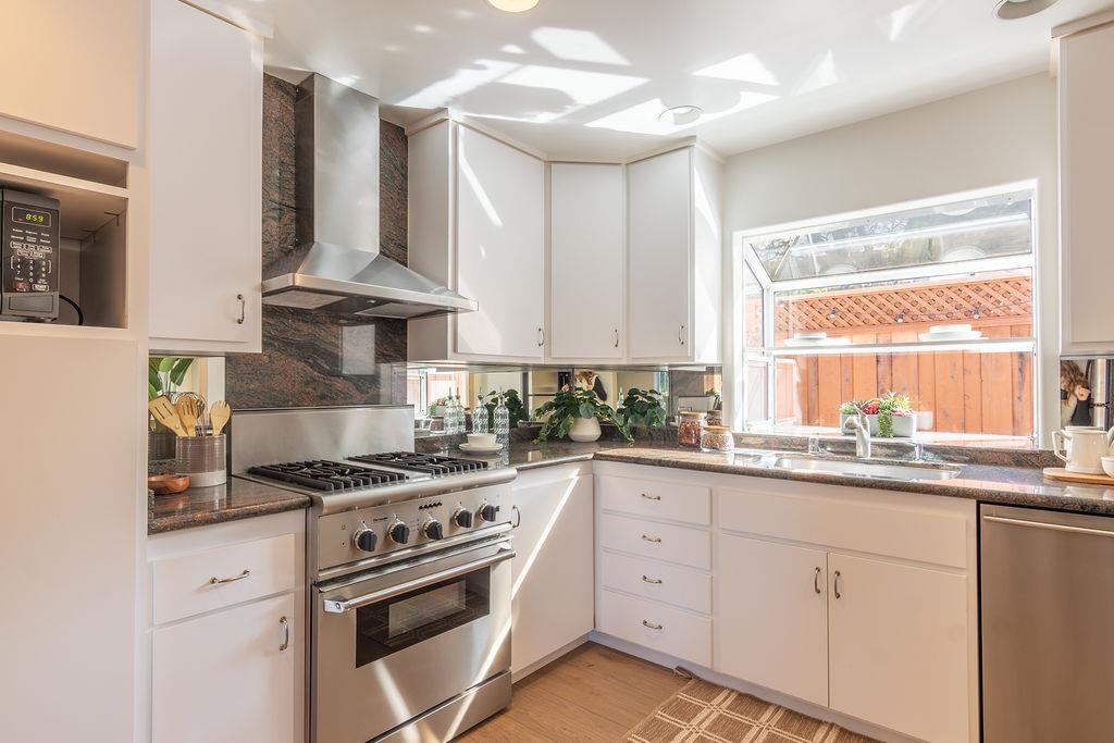 3455 Dover Road Redwood City, CA 94061 - Photo 16 of 39 a kitchen with cabinets appliances a sink and a window