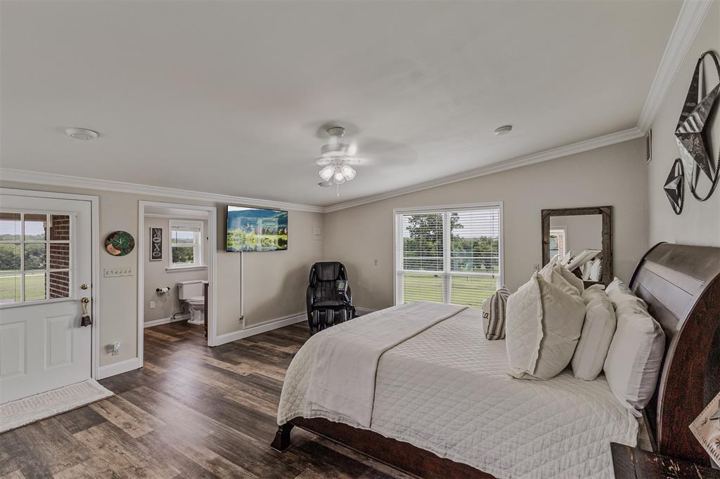 339 Colwell Road Forestburg, TX 76239 - Photo 5 of 31 Large primary bedroom with ensuite bathroom and direct access to the outdoors of 339 Colwell Rd in Forestburg, TX