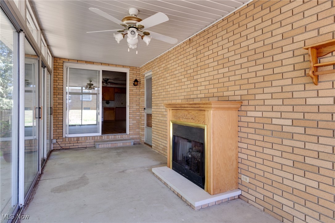 3433 Greenwich Road Barberton, OH 44203 - Photo 21 of 41 This sunroom is right off the kitchen and leads to the backyard through a wall of sliding glass doors for a gorgeous view of the backyard! It also has a beautiful gas fireplace and a lighted ceiling fan.