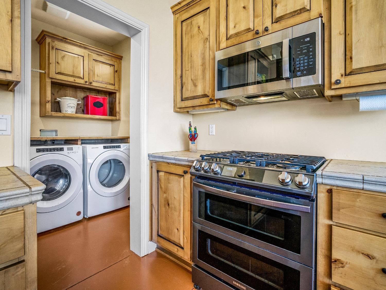 6801 Sagittarius Road Placerville, CA 95667 - Photo 32 of 34 a kitchen with stainless steel appliances granite countertop a stove and a microwave