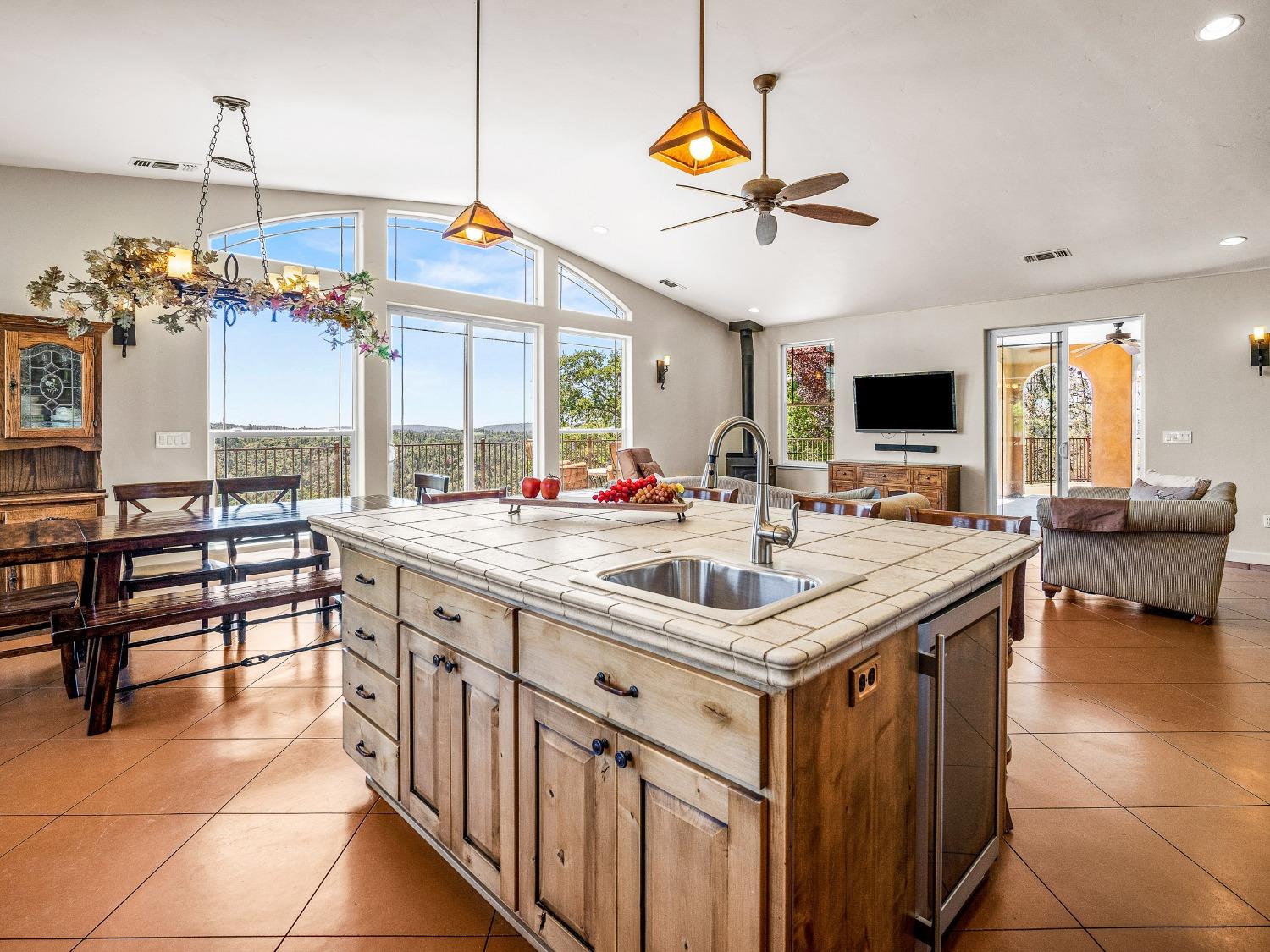6801 Sagittarius Road Placerville, CA 95667 - Photo 7 of 34 a kitchen with a stove a counter space a sink and living room view