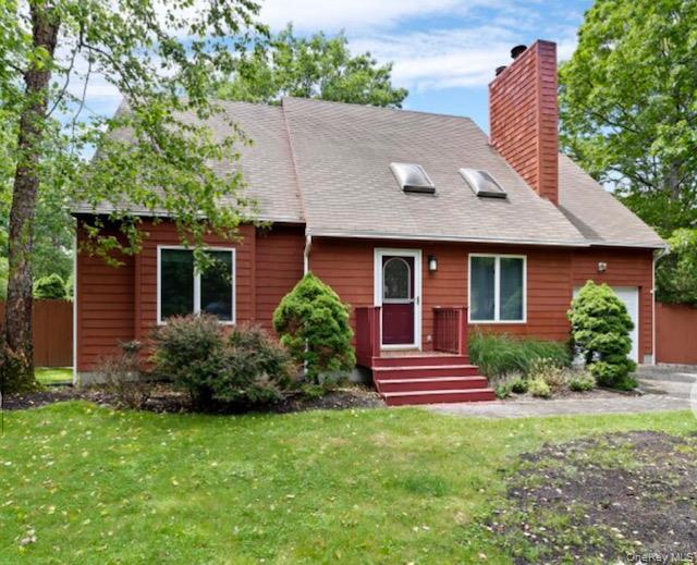 12 Hildreth Road Hampton Bays, NY 11946 - Photo 20 of 21 Cape cod-style house featuring a garage and a front yard