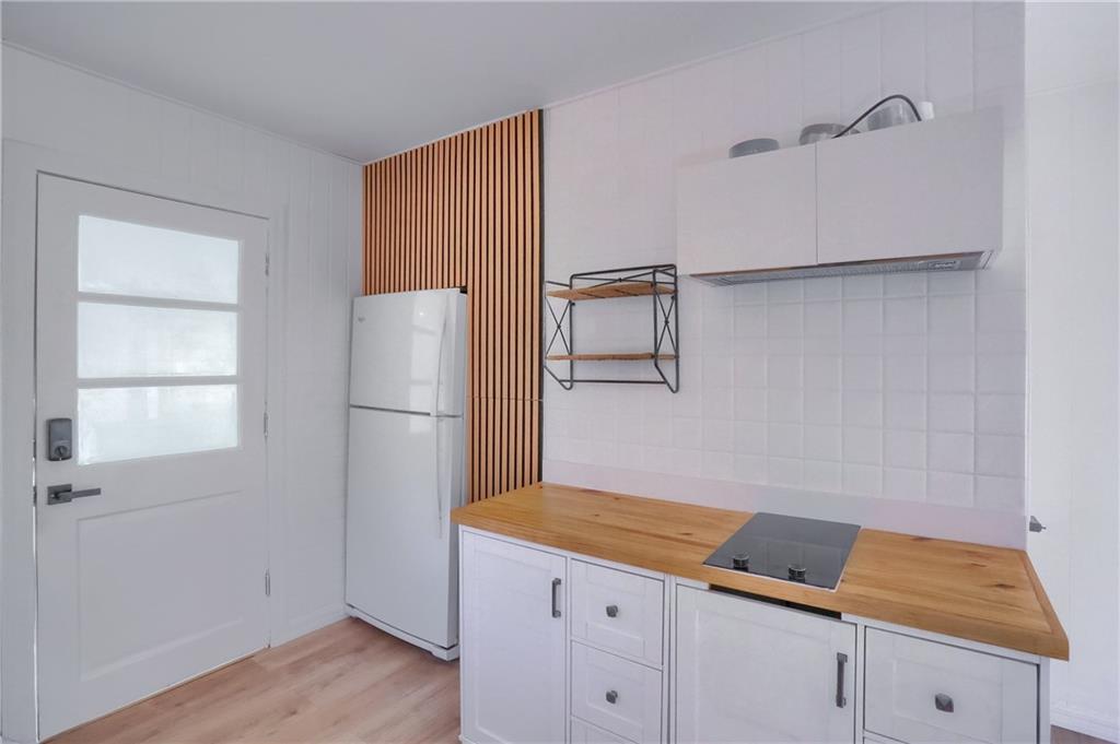 5848 Saltsburg Road Verona, PA 15147 - Photo 11 of 23 a kitchen with cabinets and wooden floor