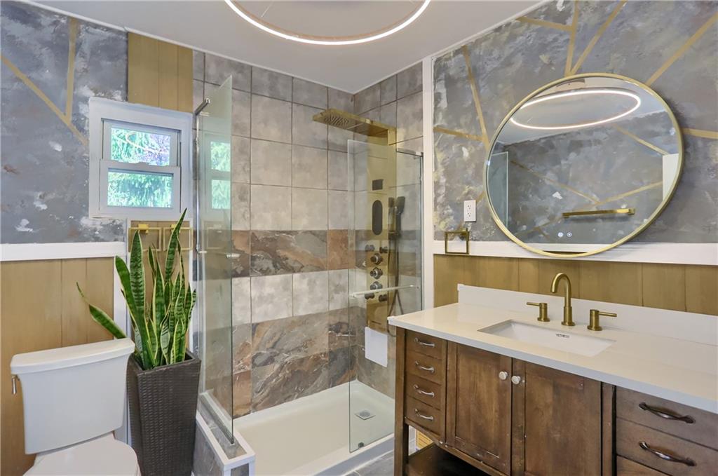 5848 Saltsburg Road Verona, PA 15147 - Photo 16 of 23 a bathroom with a sink a mirror and a bathtub