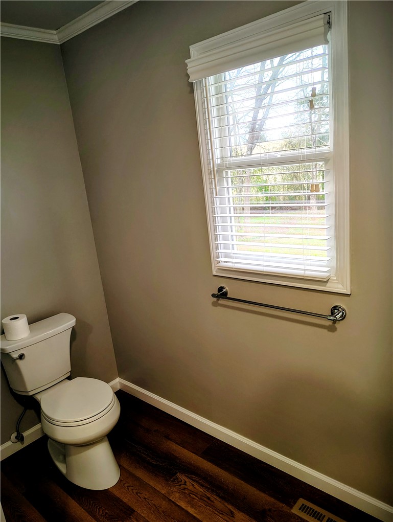 1809 Busby Road Anderson, SC 29626 - Photo 18 of 43 This bathroom features durable flooring, a toilet, and a window for natural light.